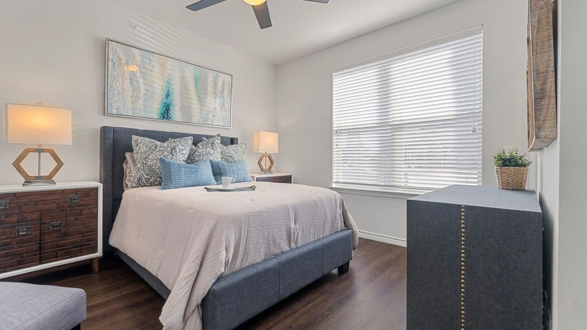 a bedroom with a large bed and ceiling fan at The Auberge of Burleson