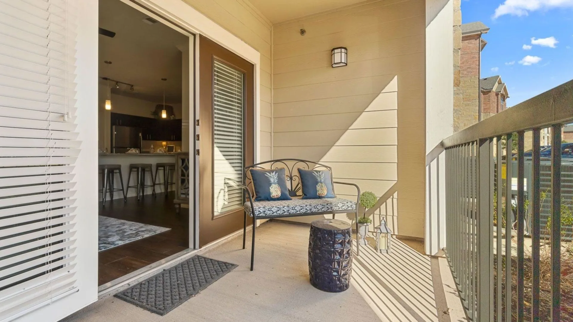 the balcony of a home with a patio and chairs at The Auberge of Burleson