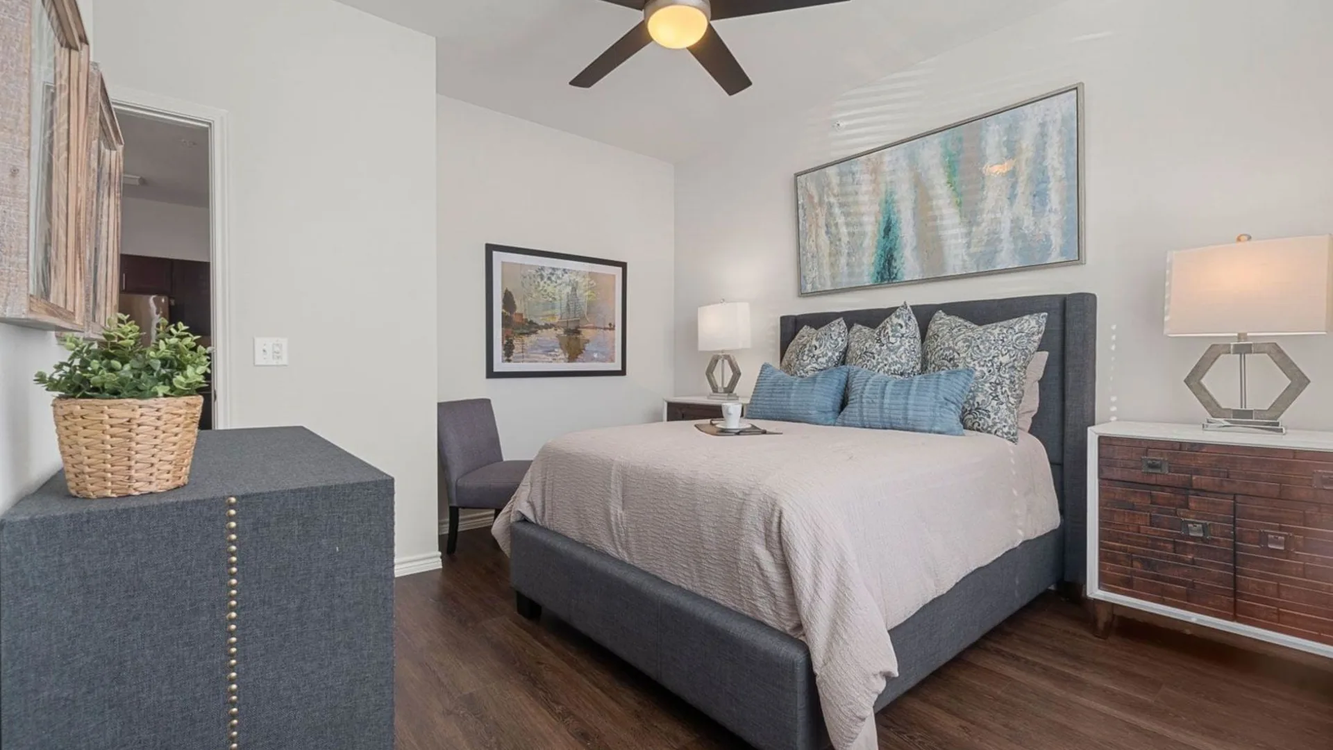 a bedroom with a ceiling fan and hardwood floors at The Auberge of Burleson