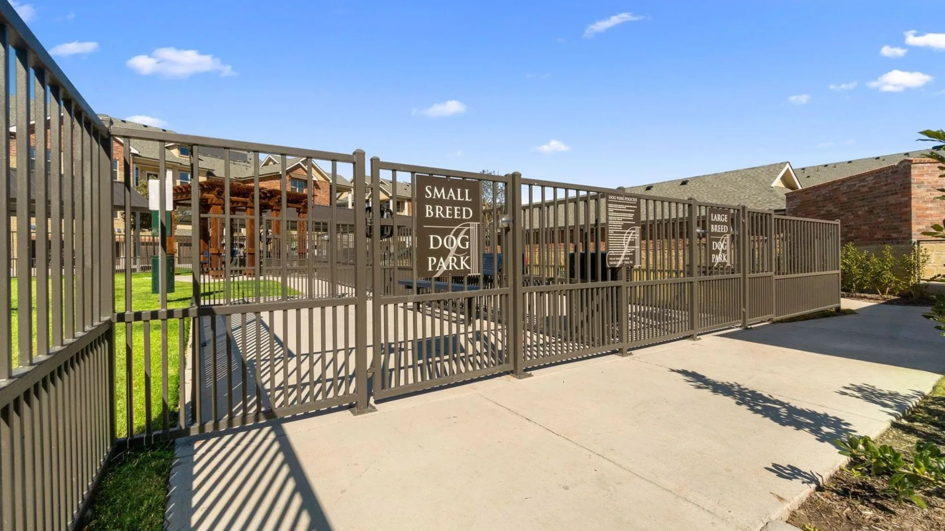 a gate with a fence and a driveway at The Auberge of Burleson