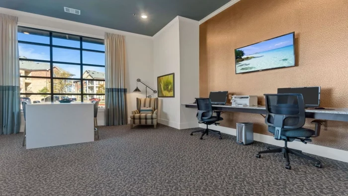 a clean and modern office with a desk and computer at The Auberge of Burleson