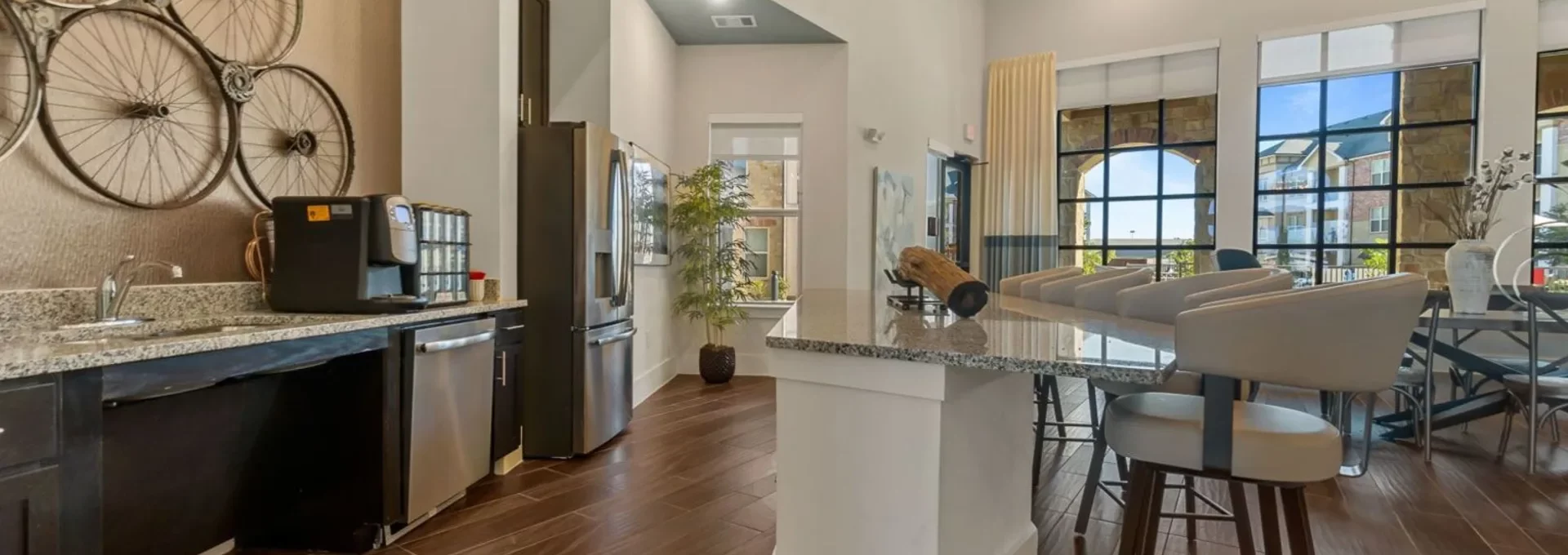 a kitchen with a large island and a large dining table at The Auberge of Burleson